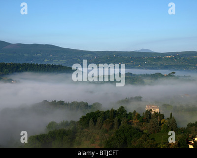 Fabulous landscape of the foggy morning in Tuscany. The valley between Montepulciano and Chiusi Stock Photo