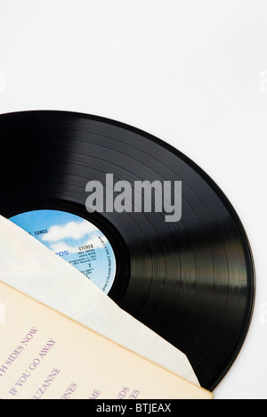 Vinyl record, partially enclosed in it's protective sleeve. Stock Photo