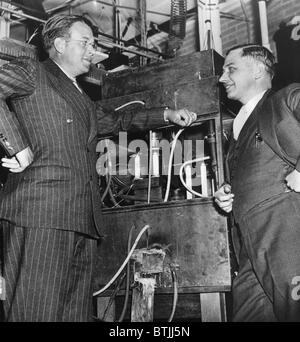 Ernest O. Lawrence, American physicist and Nobel Laureate, and Dr. Lee Alvin DuBridge (1901-1994), inspecting an atom smasher at Stock Photo