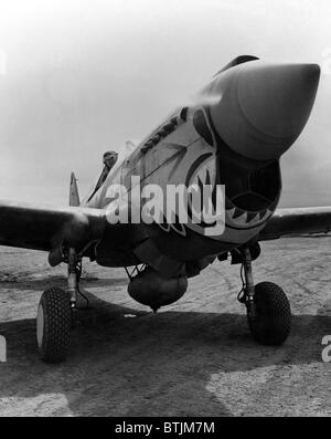 One of the redoutable 'Flying Tigers' ready to take off from an Alaskan point in a Curtis P-40 'Warhawk' fighter plane. ca. 1940-1946 Stock Photo