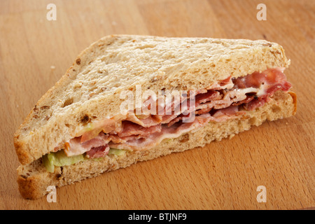 single triangle blt bacon lettuce tomato sandwich in malted brown malt bread Stock Photo