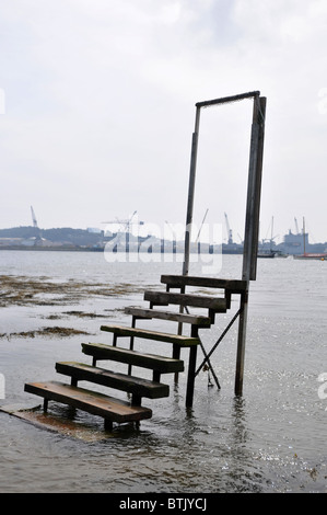 steps and a door frame leading to nowhere but the sea Stock Photo