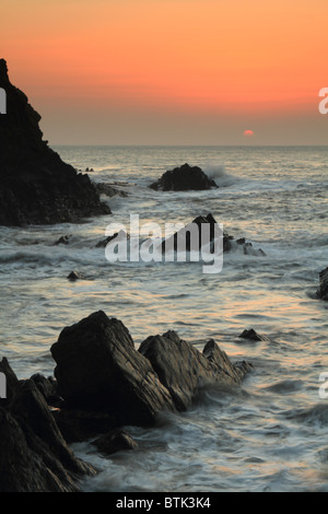 Sunset over rocks at Hartland Quay, North Devon, England, UK Stock Photo