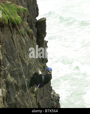 Youngsters at an adventure training centre in Cornwall learning to tackle rock climbing and abseiling safely. Stock Photo
