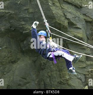 Youngsters at an adventure training centre in Cornwall learning to tackle rock climbing and abseiling safely. Stock Photo