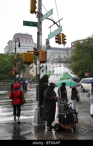 An umbrella seller on Broadway, New York City, USA