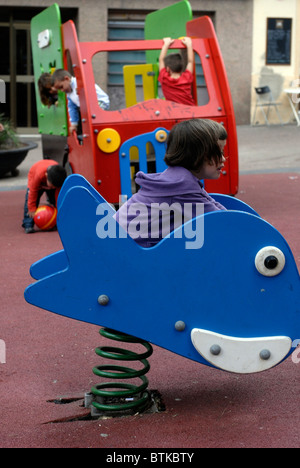 Children playing in a playground at Barcelona, Spain. Stock Photo