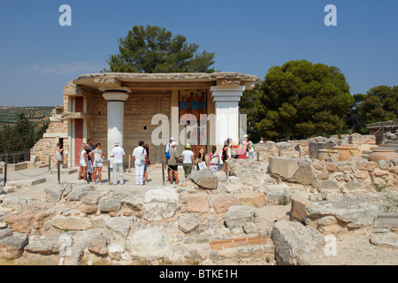 Visitors look at the Procession Fresco at South Propylaeum in Knossos Palace, showing an ancient ceremonial cult procession. Crete, Greece. Stock Photo