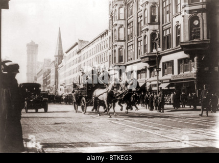 Horse-drawn fire engines in street, on their way to the Triangle Shirtwaist Company fire, New York City. Their ladders extended Stock Photo