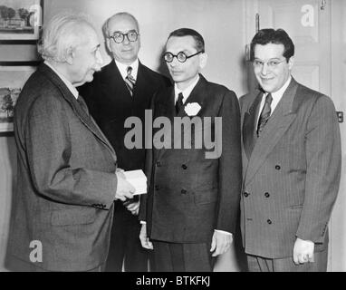 Mathematician Kurt Godel (1906-1978), receives the first Albert Einstein award for achievement in the natural sciences as physicist Julian Schwinger and Lewis Strauss look on. 1951. Stock Photo