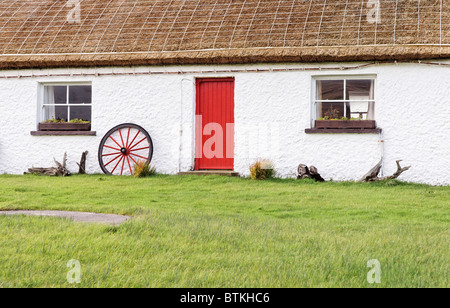 A thatched cottage with a red door at the Glencolmcille Folk Village, County Donegall, Ulster, Eire. Stock Photo