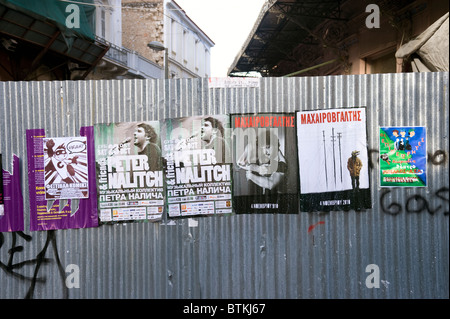 Posters on a fence made of corrugated metal, Athens, Greece Stock Photo