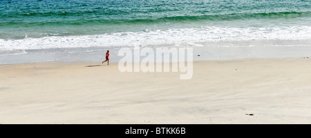 Man running on sandy beach. Keem Bay, Achill Island, County Mayo, Connaught, Ireland. Stock Photo