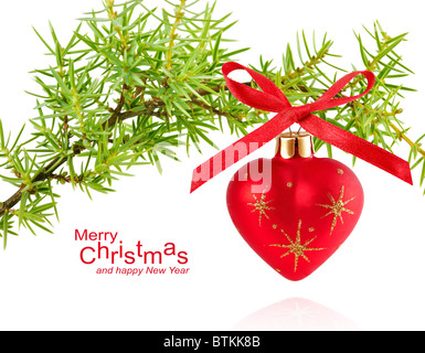 spruce branch with Christmas ball in the form of heart Stock Photo