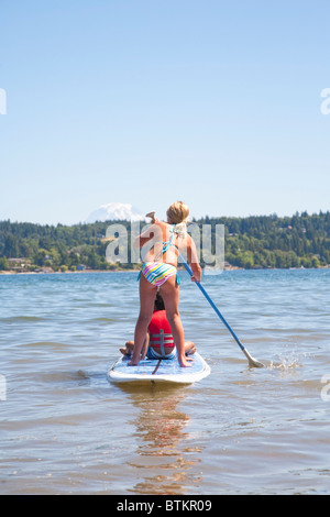 boy and girl on paddle board Stock Photo