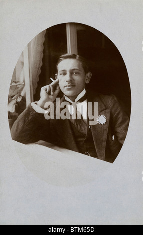 Historical photo (1910) of a man smoking a cigarette Stock Photo