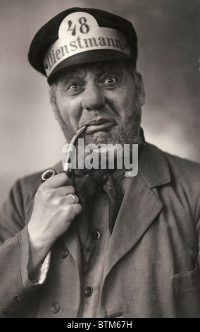 Historical photo (1910) of a man smoking a pipe Stock Photo