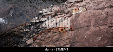 Rusting mooring rings and chain at Port An Amaill. By Rua Reidh Lighthouse. Nr Melvaig, Highland, Scotland Stock Photo
