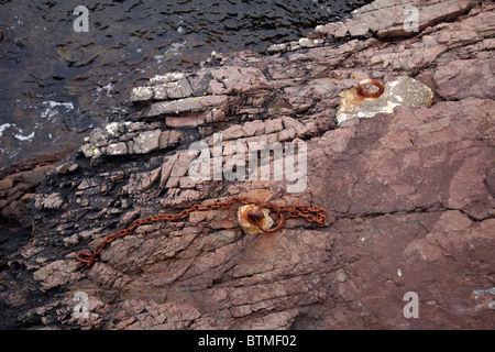 Rusting mooring rings and chain at Port An Amaill. By Rua Reidh Lighthouse. Nr Melvaig, Highland, Scotland Stock Photo