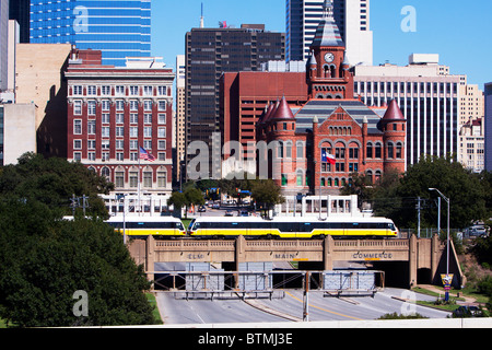 A Dallas Area Rapid Transit (DART) Light Rail train cruises above traffic in downtown Dallas, Texas. Stock Photo