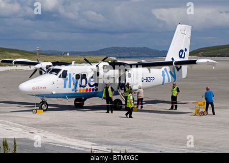 A twin Otter Aircraft Boarding on the cockleshell beach at Barra Airstrip, Outer Hebrides, Scotland.  SCO 6603