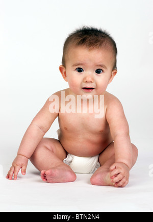 Happy baby boy 1 year old sitting on the grass and posing in green park in  summer day Stock Photo - Alamy