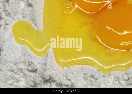 close up of broken eggs and white flour for making pasta Stock Photo