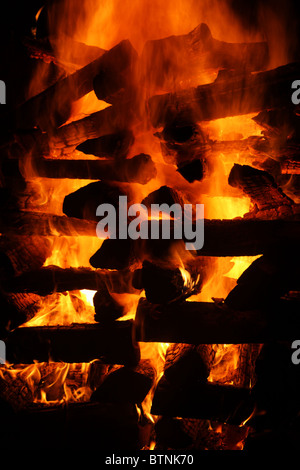 blazing log bonfire detail with black background Stock Photo