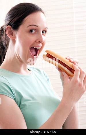 teeen eating hot dog Stock Photo
