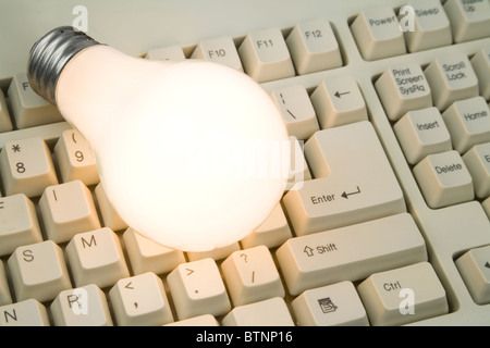 Light Bulb and Computer Keyboard close up shot Stock Photo