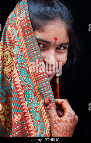 Indian girl wearing traditional silk sari with henna hands. India. Face portrait Stock Photo