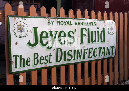 Old fashioned metal advertising sign on display at a  '[steam railway station' Stock Photo