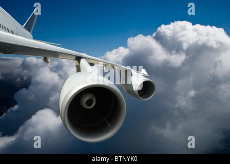 The white Airplane flying above clouds Stock Photo