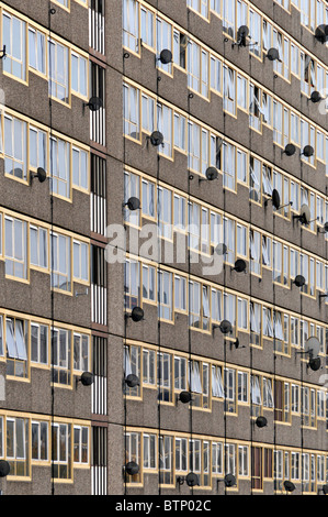 Satellite television aerial receiver dishes on walls of London Borough of Southwark Council flats at Elephant & Castle on Heygate Estate England UK Stock Photo