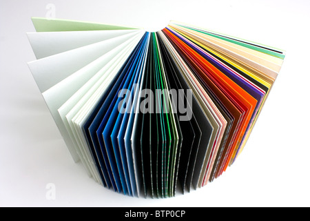 coloured papers bound in a book on white background Stock Photo