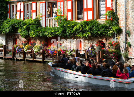 Canal cruising past antique shop, Dijver, Bruges, Belgium, Europe Stock Photo