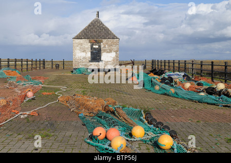 Fishing nets drying outside anold harbour light building Maryport Cumbria England UK GB Stock Photo