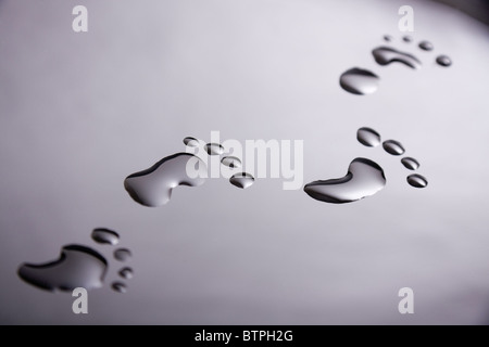 Footprints made from water drops Stock Photo