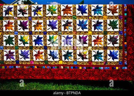 Close up autumn leave Maple leaf quilt, duvet abstract pattern, hanging on a clothesline in Lancaster Co., Pennsylvania, USA, washing bedspread Stock Photo