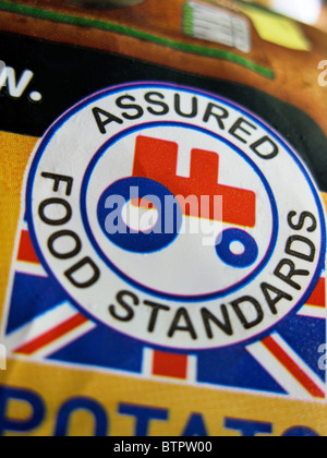 British farm standard logo from the assured food standards association of the little red tractor symbol on a packet of chips Stock Photo