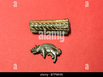 A silver gilt boar badge and part of the hilt from a sword found on the new site of the battle of Bosworth. Stock Photo