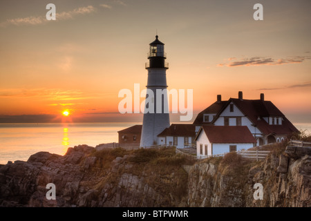 Sunrise at Portland Head Light, which protects mariners entering Casco Bay.  The lighthouse is in Cape Elizabeth, Maine. Stock Photo