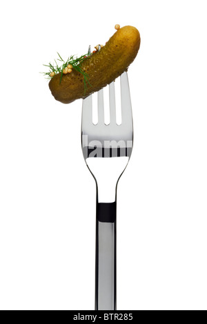 pickled cucumber sticking on a fork, garnished with mustard seed and dill, cutout Stock Photo