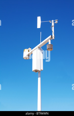 A weather station with anemometer, thermometer, and rain gauge. Stock Photo