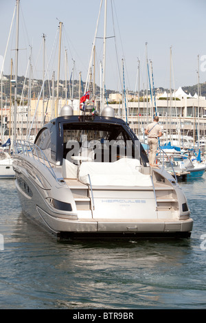 Power boat being moved by single handed remote control leaving berth at Cannes harbour France Stock Photo