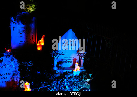 An imitation Halloween graveyard and headstones are eerily lit in the yard of a home in Oklahoma City, Oklahoma, USA. Stock Photo