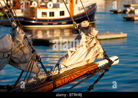 Late afternoon view through the bowsprit of a small schooner in the Camden Harbor, Maine USA Stock Photo