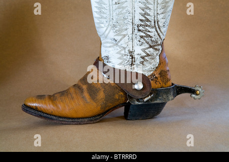 Well worn cowboy boots and spurs Stock Photo