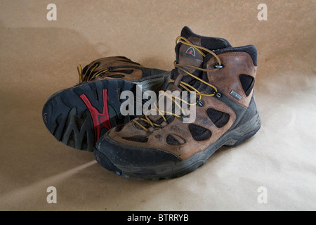 A pair of worn out lace up hiking boots. Stock Photo