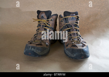 A pair of worn out lace up hiking boots. Stock Photo